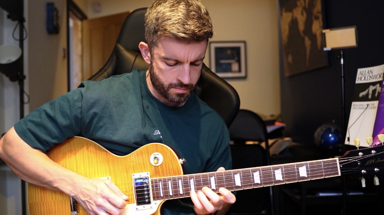 James playing electric guitar in his home studio